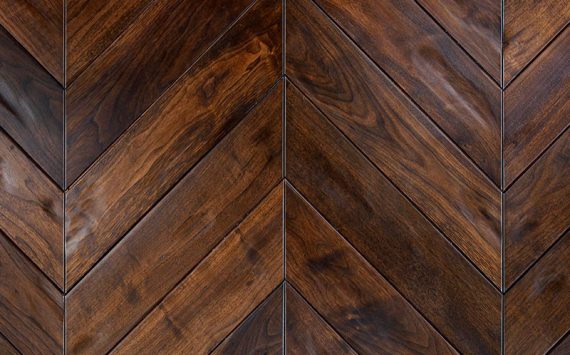 Chevron 45° wood floor in American Walnut: aged effect, hand carved, stained, varnished, rounded bevels.