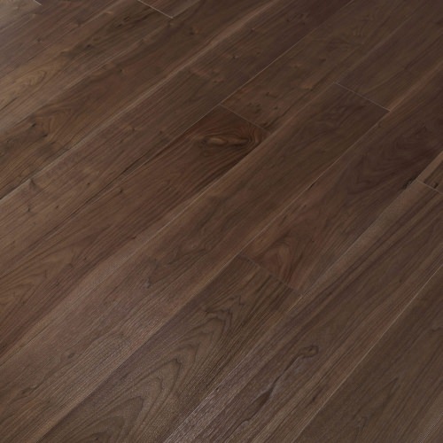Engineered wood planks floor in American Walnut: brushed, stained, varnished.